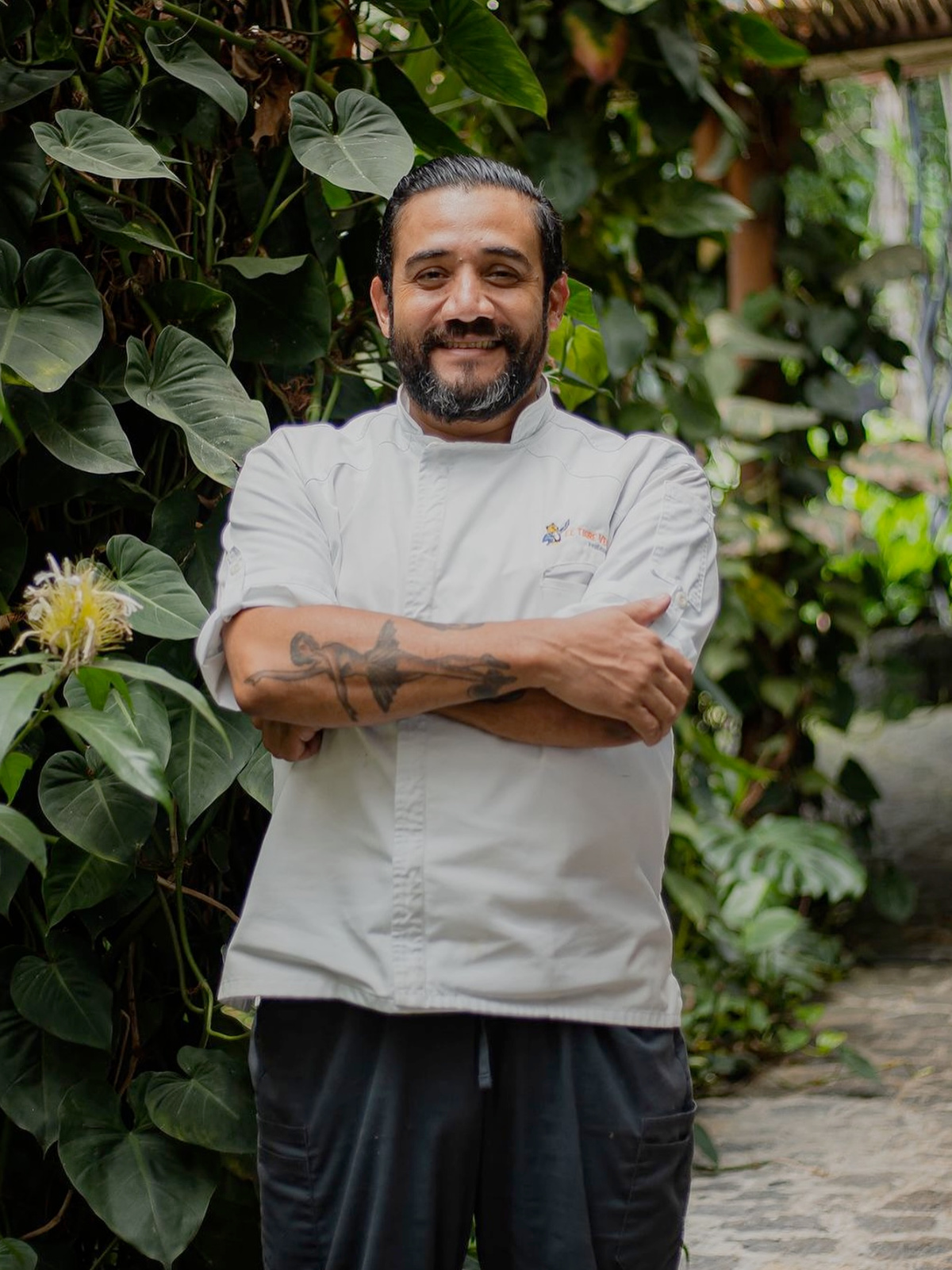 A Costa Rican coffee farmer proudly holding freshly picked coffee cherries