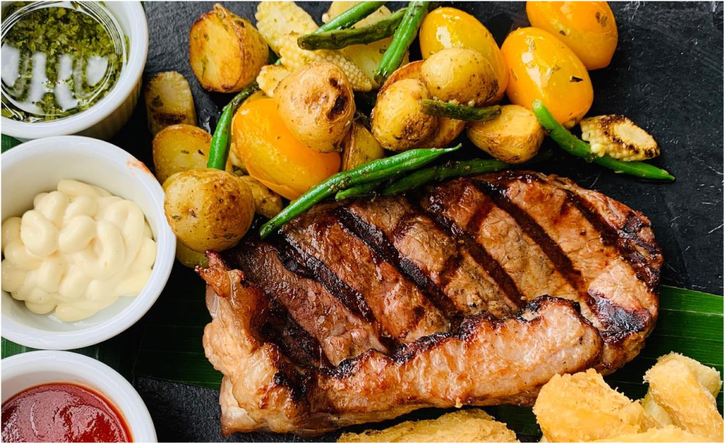 The charming whitewashed main building of Finca Rosa Blanca surrounded by tropical gardens